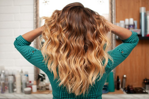 Woman with dark blonde, brunette and blonde ombre